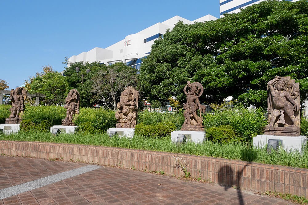 10 statues of gods near the intersection with the Fukuoka Tower in front